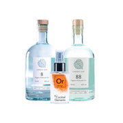 Two Linden Leaf Organic Molecular Gin bottles with cork stoppers, one labeled '8' and one labeled '88', with orange Cocktail Elements spray bottle positioned between them on white background